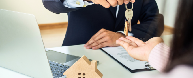 One person handing over house keys to another