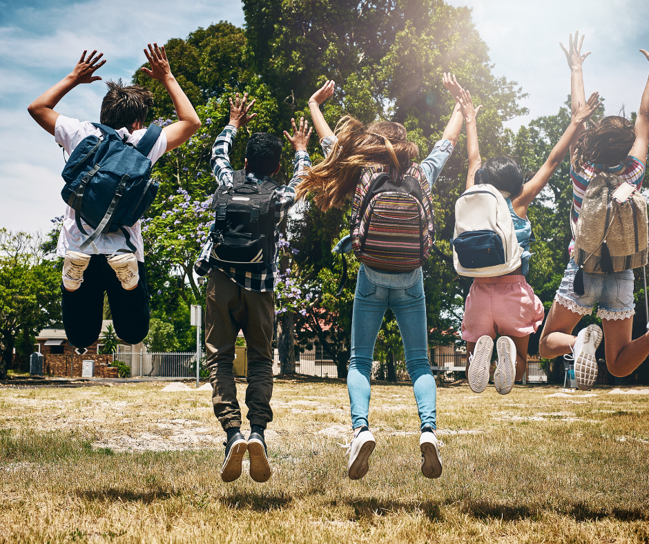 Kids with backpacks jumping in the air