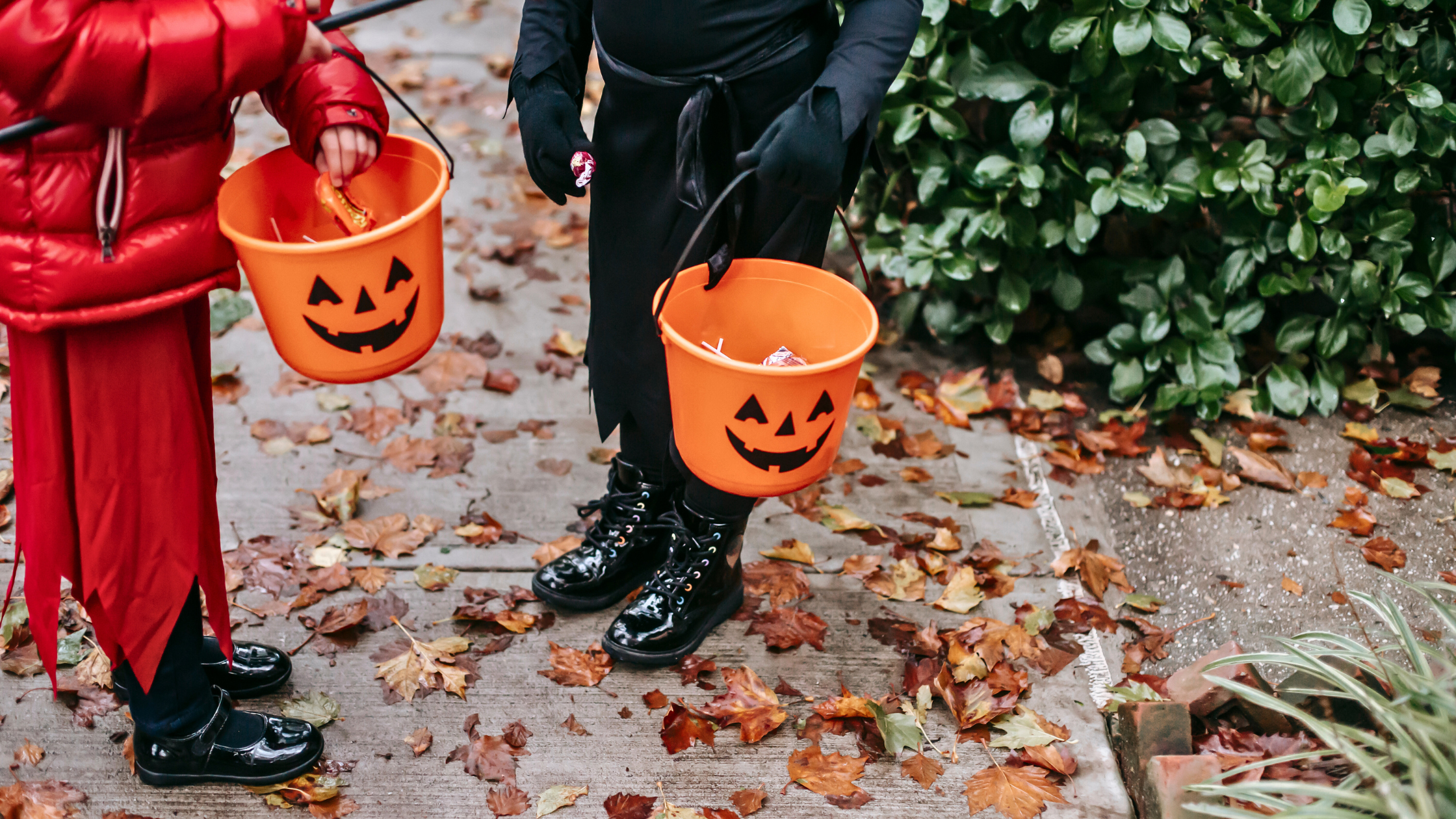 children holding halloween baskets with candy for Trick or Treating