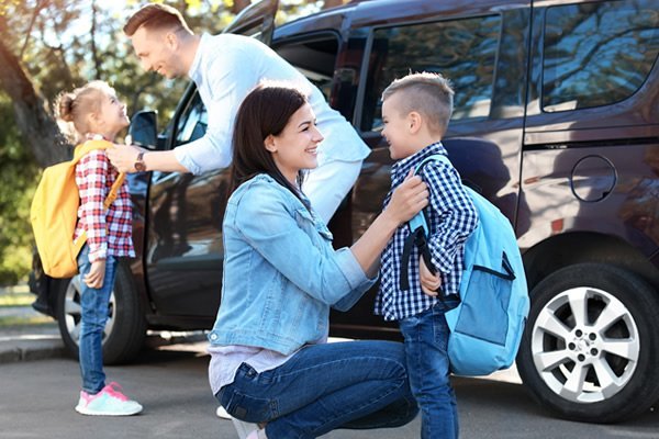 A mom dropping her son off at school.