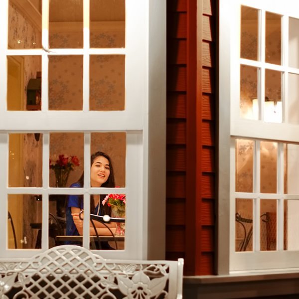 A woman looking through a window.