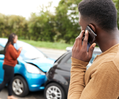 A man on the phone after a car accident