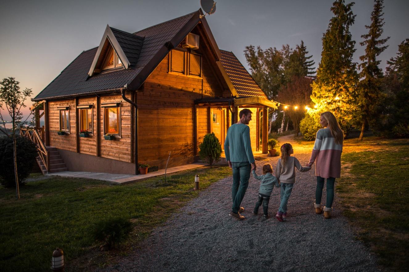 A family of four walking toward their cabin on a summer evening.