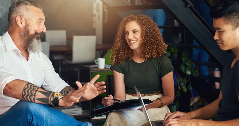 A group of people sitting and discussing ideas