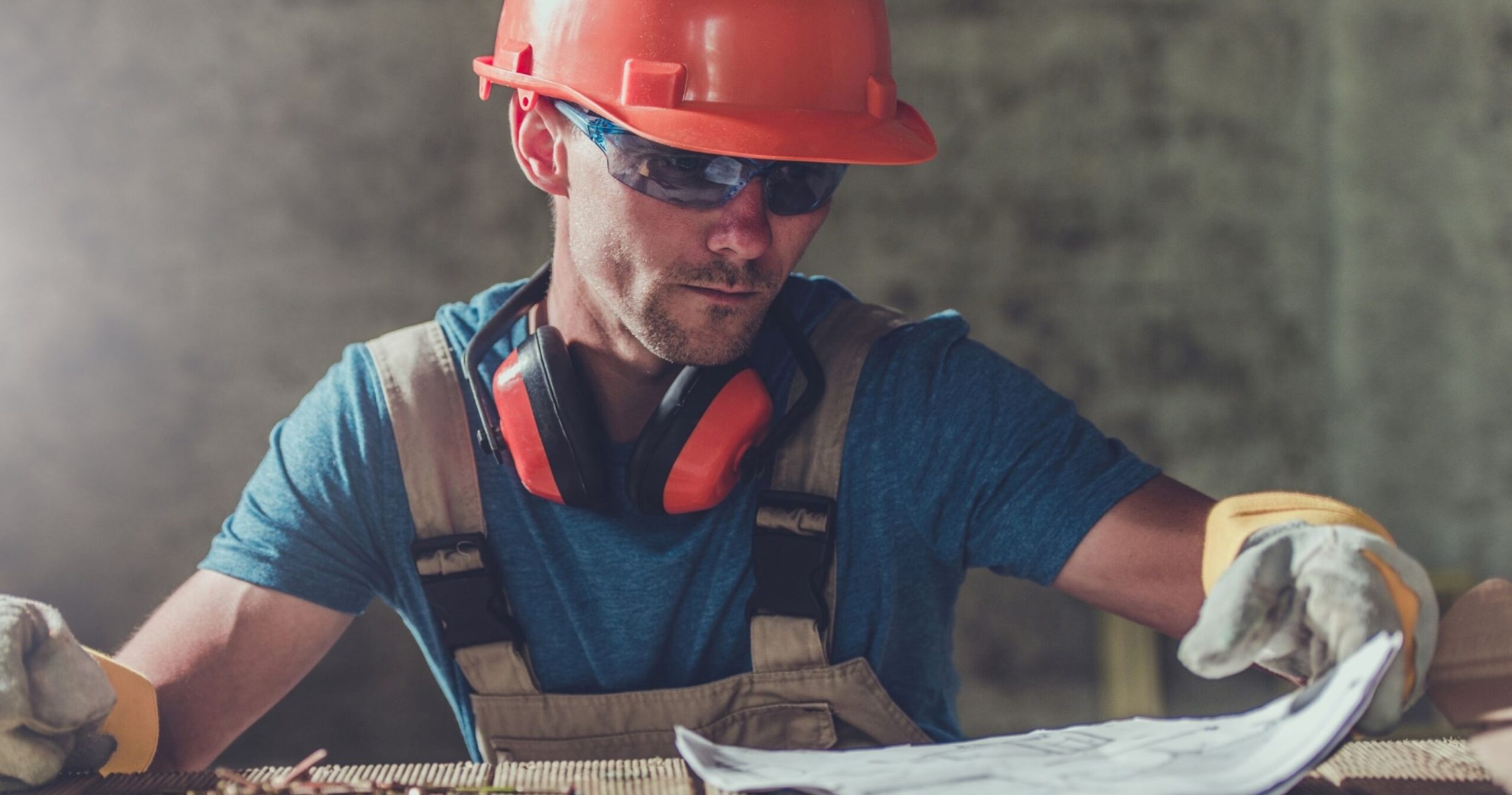 A contractor looking down at plans of the building.