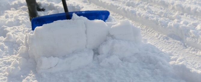 Person shoveling the snow with a snow shovel