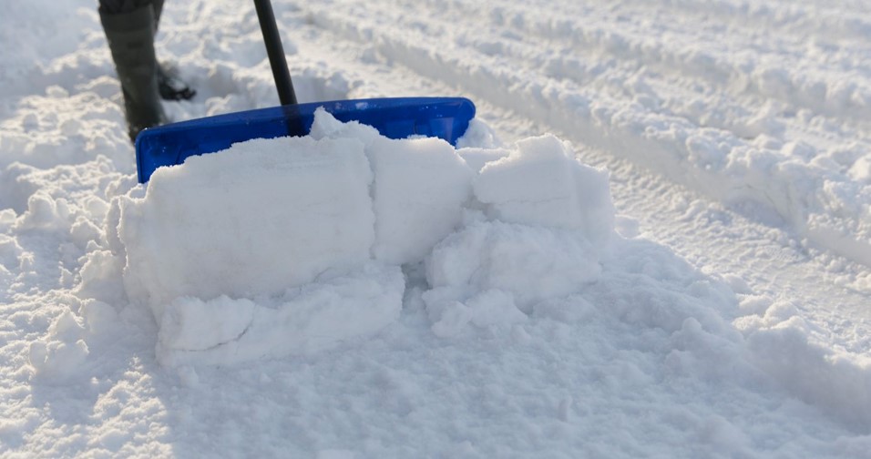 Person shoveling the snow with a snow shovel