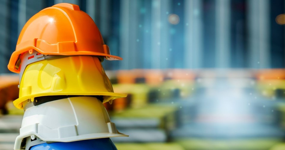 different colored hard hats stacked on top of one another